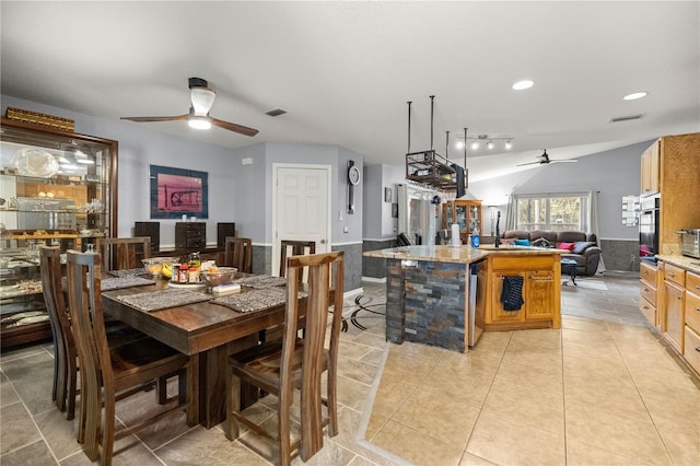 dining room featuring ceiling fan, light tile patterned floors, recessed lighting, beverage cooler, and wainscoting