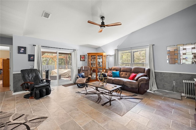 living room with lofted ceiling, visible vents, ceiling fan, and radiator heating unit