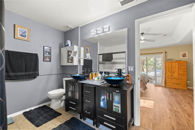 full bath with a stall shower, visible vents, a sink, and double vanity