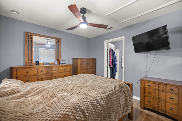 bedroom featuring visible vents, ceiling fan, wood finished floors, a spacious closet, and a closet