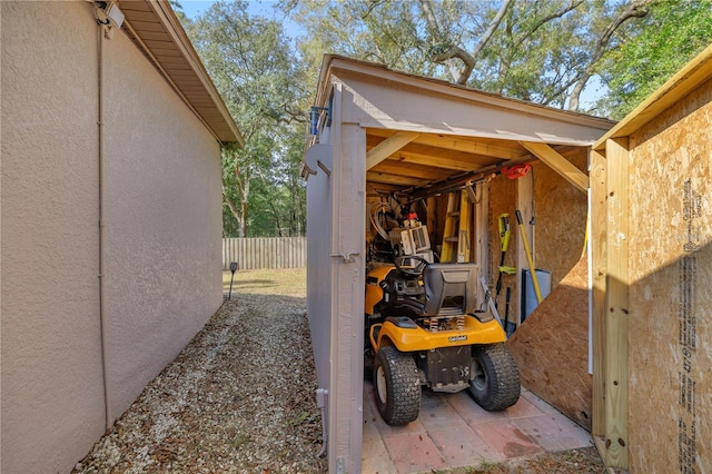 exterior space featuring fence and an outdoor structure