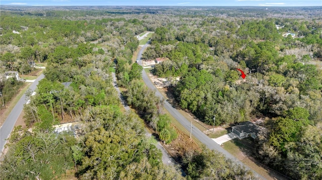 drone / aerial view featuring a view of trees