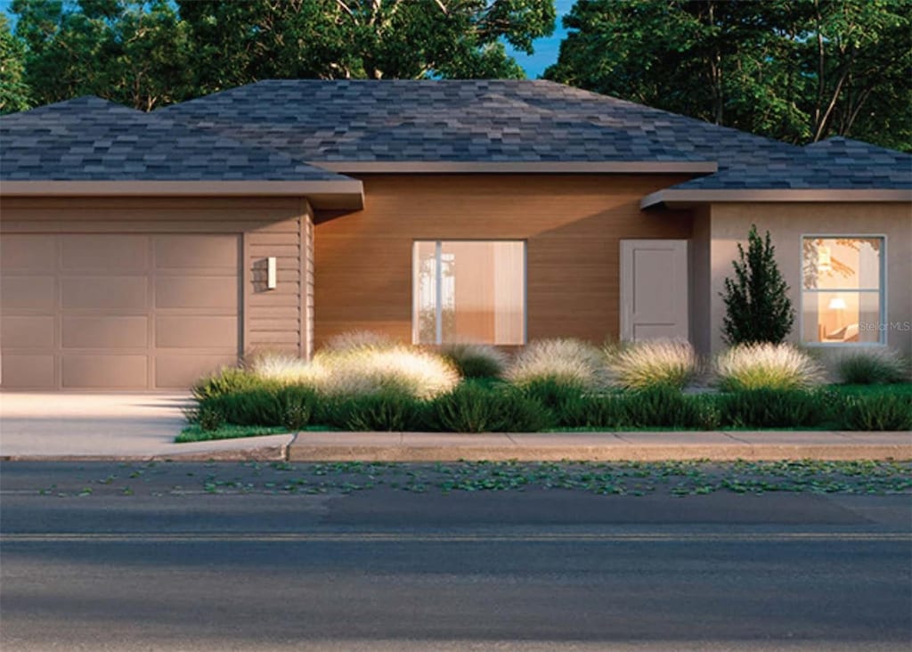 garage featuring concrete driveway