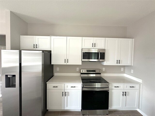 kitchen featuring white cabinets, light countertops, and appliances with stainless steel finishes