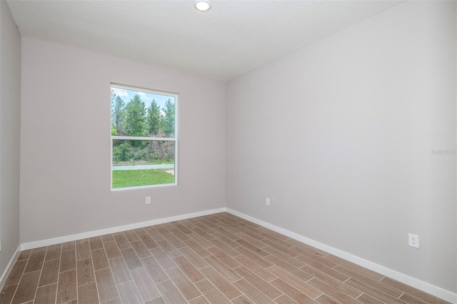 3085 SW 131st Place Rd, Ocala, FL 34473 - unfurnished room with baseboards, wood finished floors, and recessed lighting