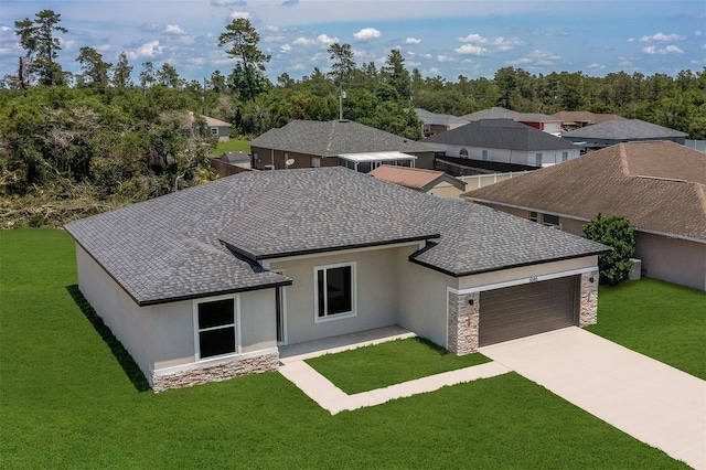 3085 SW 131st Place Rd, Ocala, FL 34473 - prairie-style home featuring a shingled roof, a garage, and a front yard