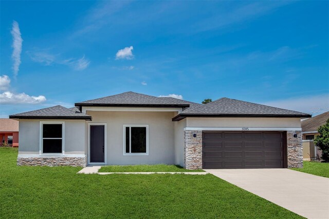 3085 SW 131st Place Rd, Ocala, FL 34473 - prairie-style house with stone siding, a garage, stucco siding, and a front yard