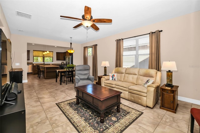7234 SW 91st Ct, Ocala, FL 34481 - living area with ceiling fan, plenty of natural light, baseboards, and light tile patterned floors