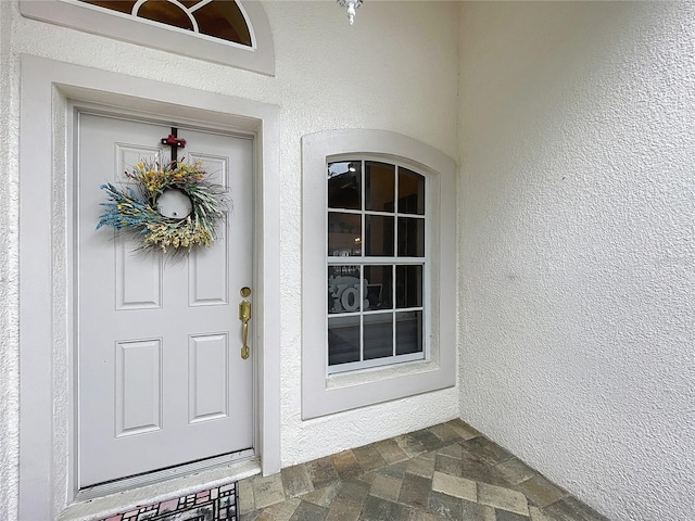 entrance to property with stucco siding