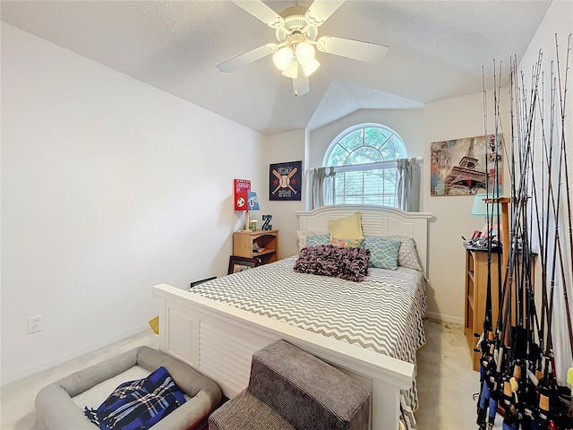 bedroom with lofted ceiling, a textured ceiling, light carpet, and a ceiling fan