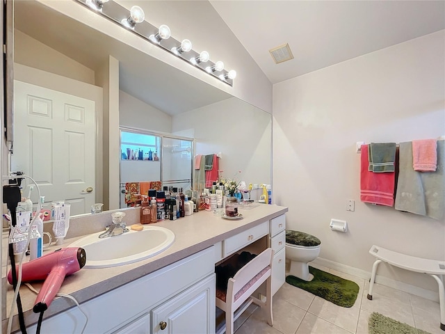 bathroom featuring visible vents, vaulted ceiling, a shower stall, vanity, and tile patterned flooring