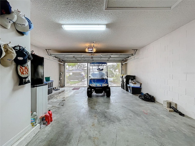 garage with concrete block wall and a garage door opener