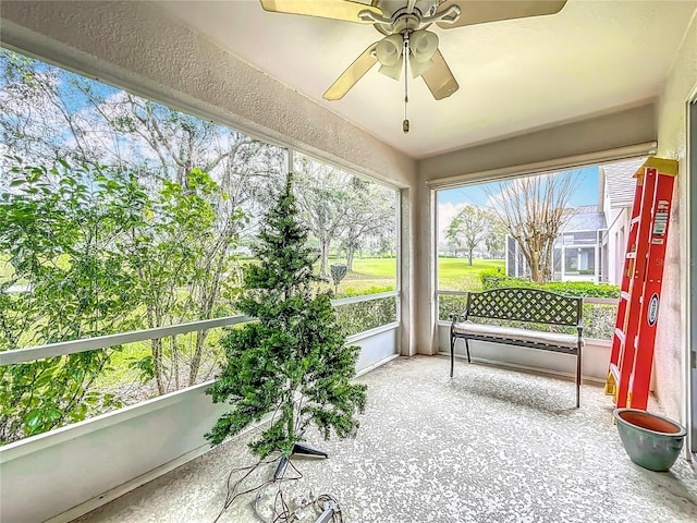 sunroom featuring ceiling fan