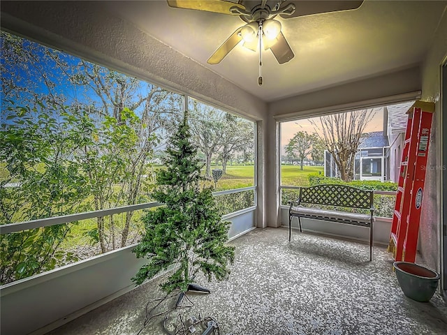 sunroom featuring ceiling fan