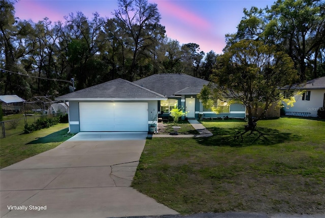 single story home featuring fence, a front yard, stucco siding, a garage, and driveway