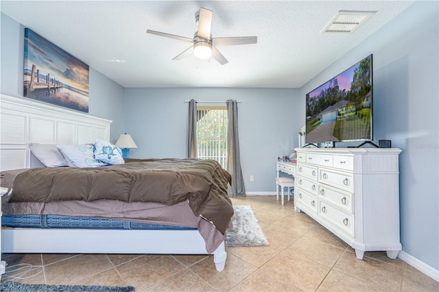 bedroom featuring light tile patterned floors, visible vents, baseboards, and a ceiling fan