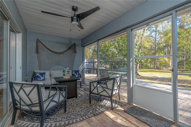 sunroom featuring ceiling fan