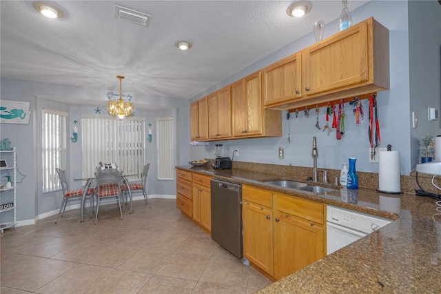kitchen featuring light tile patterned floors, visible vents, a sink, stainless steel dishwasher, and a chandelier