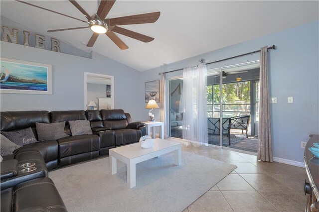 living area featuring tile patterned flooring, baseboards, a ceiling fan, and vaulted ceiling