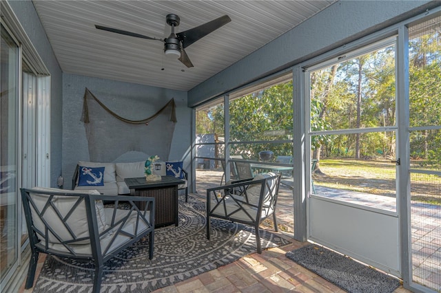 sunroom / solarium with a ceiling fan