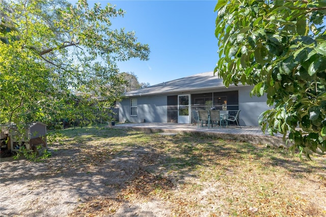 back of property featuring stucco siding and a patio