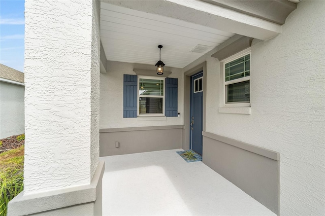 doorway to property with stucco siding