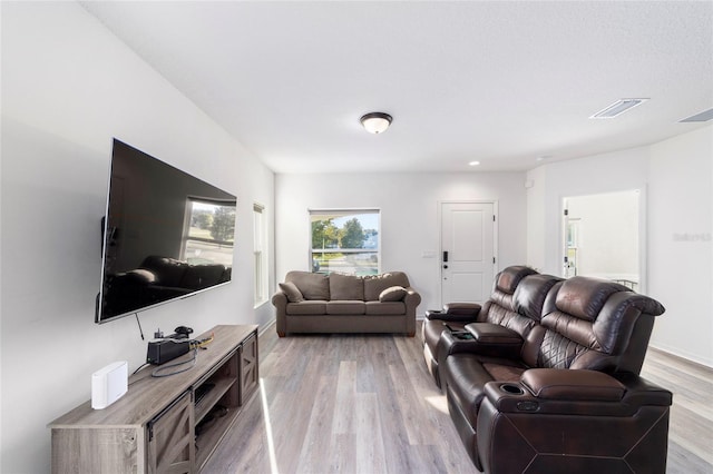 living room featuring visible vents and light wood-style floors