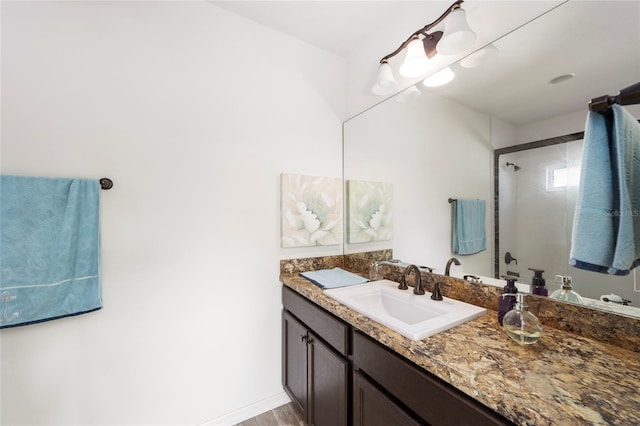 full bath with vanity and baseboards