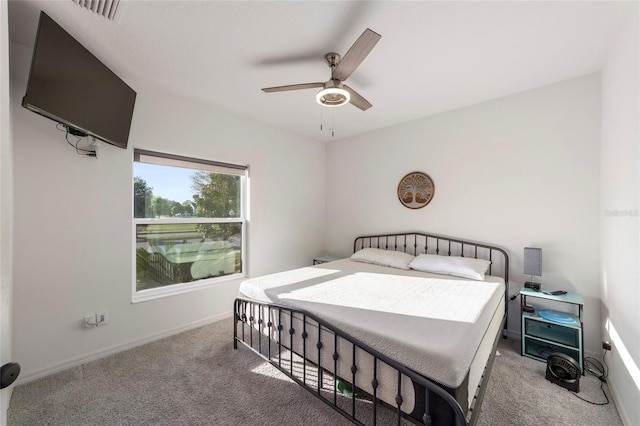 carpeted bedroom with baseboards, visible vents, and a ceiling fan