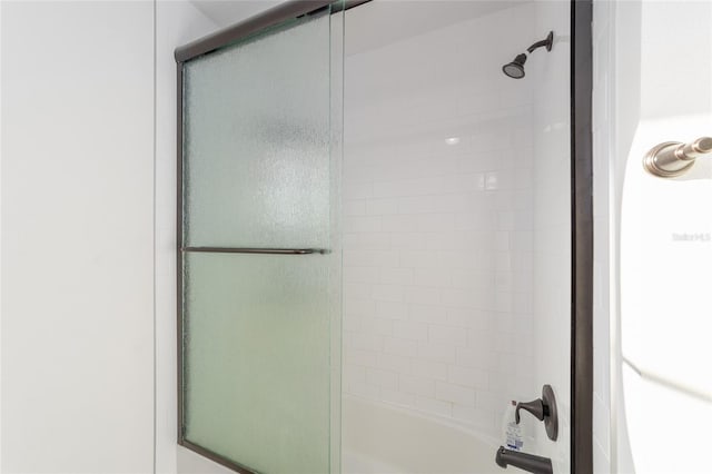 full bathroom with combined bath / shower with glass door