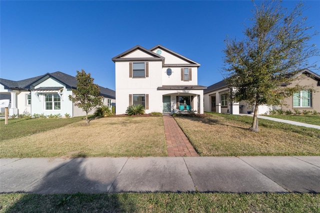 view of front of home featuring a front lawn and stucco siding