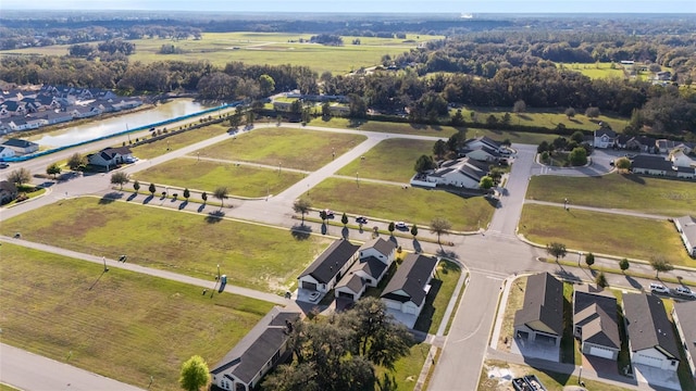 drone / aerial view featuring a water view and a residential view