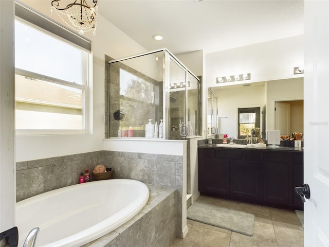 bathroom featuring a chandelier, a shower stall, vanity, and a bath