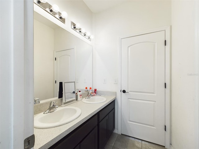 full bathroom with double vanity and a sink