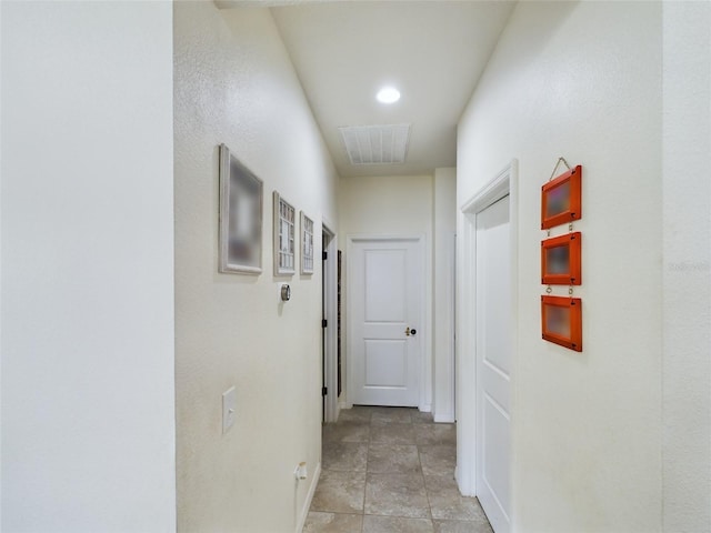 corridor featuring light tile patterned floors and visible vents