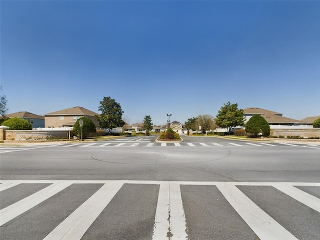 view of road with curbs, sidewalks, and street lights