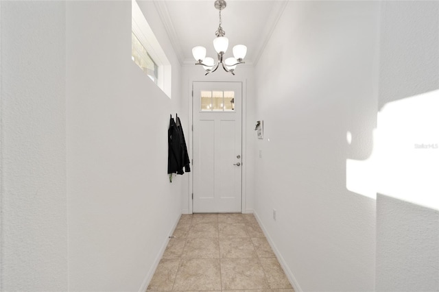 doorway to outside with ornamental molding, a notable chandelier, baseboards, and light tile patterned floors