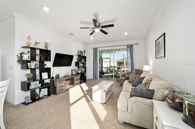 living area with ornamental molding, recessed lighting, carpet flooring, and a ceiling fan