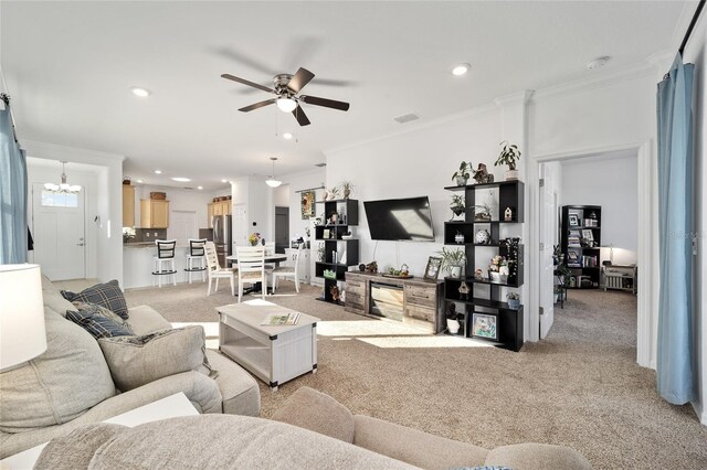 living area with recessed lighting, visible vents, crown molding, and light colored carpet