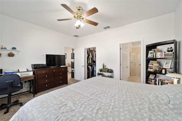 bedroom with a spacious closet, a closet, carpet, and visible vents