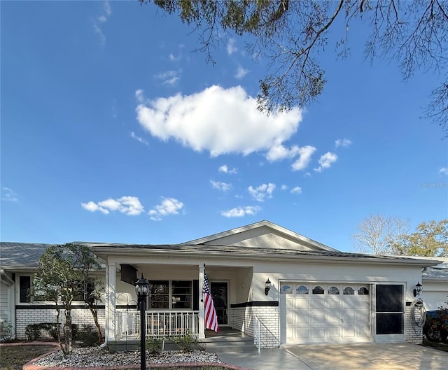 ranch-style home featuring an attached garage, covered porch, driveway, and brick siding