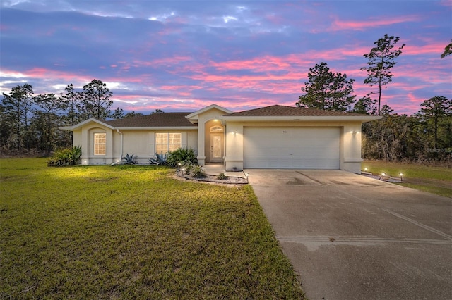 ranch-style home with a garage, concrete driveway, a front yard, and stucco siding