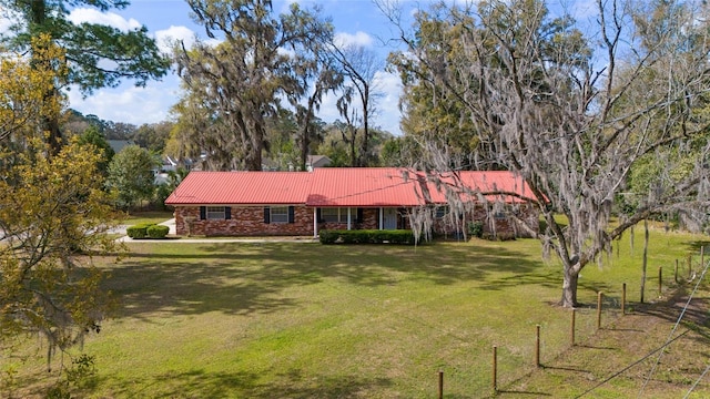 view of front of home with a front yard and metal roof