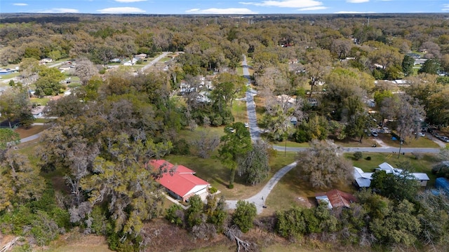 birds eye view of property featuring a view of trees