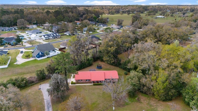 aerial view featuring a forest view and a residential view