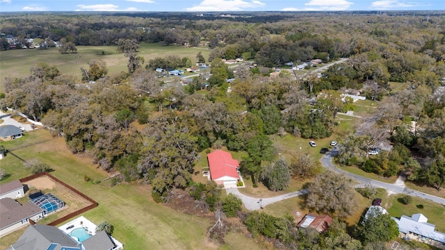 drone / aerial view featuring a wooded view