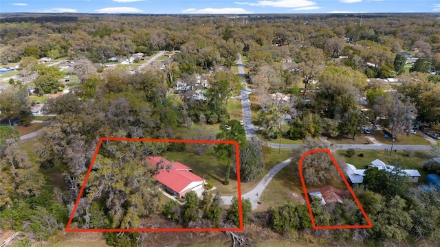 drone / aerial view with a wooded view