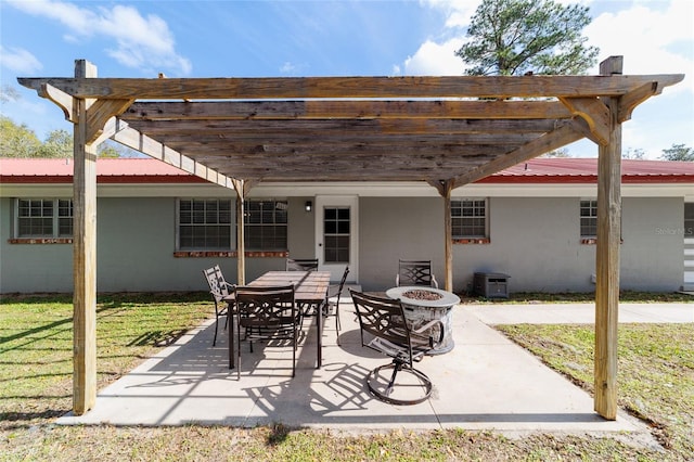 view of patio featuring a fire pit, outdoor dining space, and a pergola