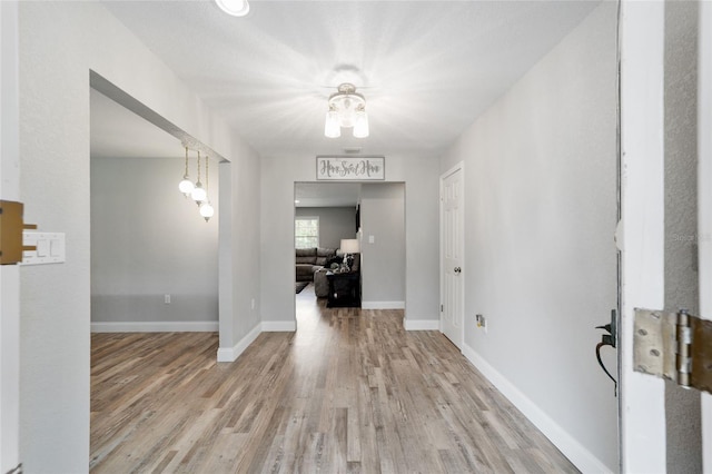 unfurnished dining area featuring baseboards and wood finished floors