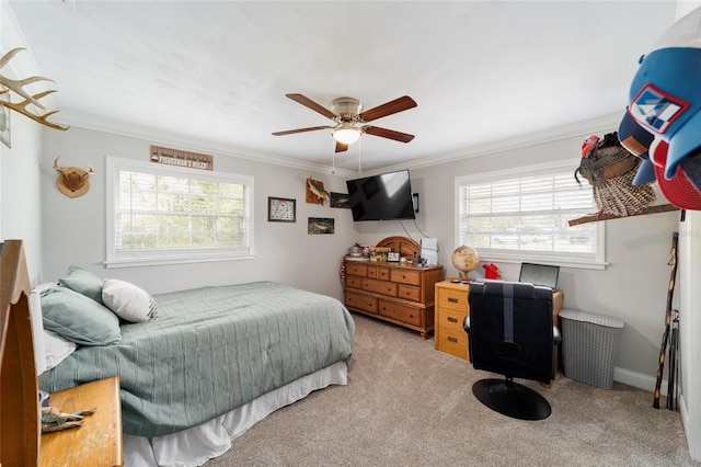 carpeted bedroom with ceiling fan, ornamental molding, and baseboards